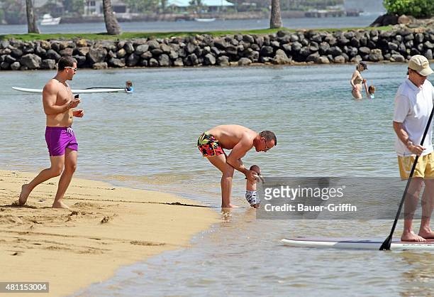 David Furnish is seen at the beach with his son Zachary Furnish-John on February 21, 2011 in Honolulu, Hawaii.