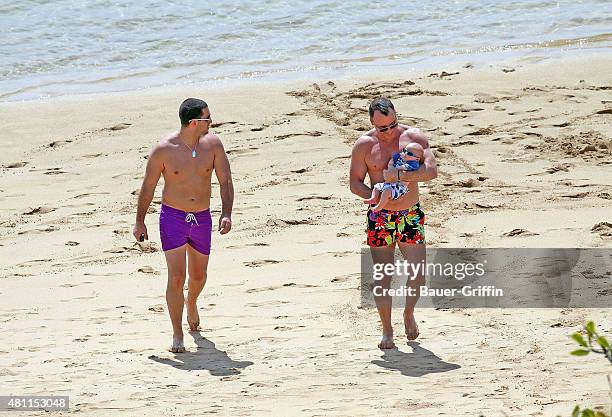 David Furnish is seen at the beach with his son Zachary Furnish-John on February 21, 2011 in Honolulu, Hawaii.