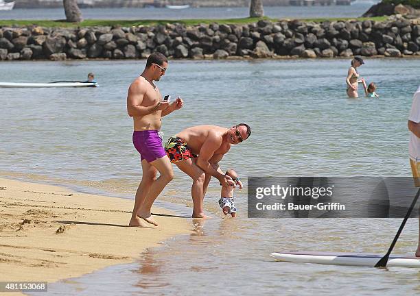 David Furnish is seen at the beach with his son Zachary Furnish-John on February 21, 2011 in Honolulu, Hawaii.