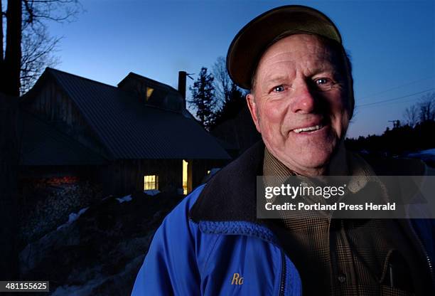 Staff Photo by Fred J. Field, Wed, Mar 19, 2003: Outside the sugarhouse at dusk, Rodney Stacey of Parsonsfield has a smile as he recalls the sweet...