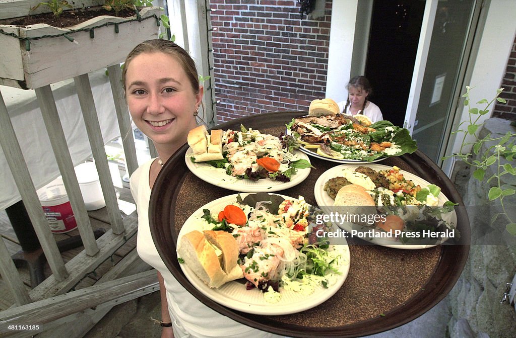 Nell Blodgett serves lunch at the Black Tie Cafe today. The entrees include Poached Salmon, Spinach ...