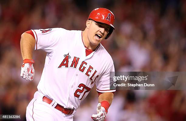 Mike Trout of the Los Angeles Angels of Anaheim reacts as he runs to first as his walk off home run clears the wall in the ninth inning against the...