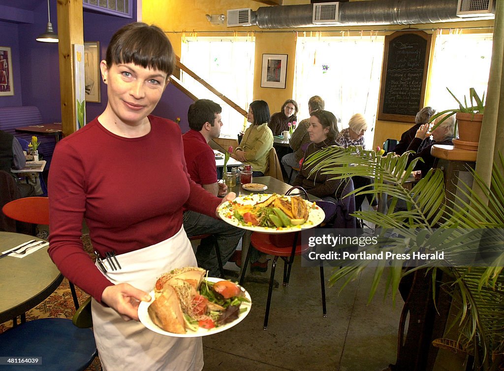 Laurie Hunt serves a turkey avacado sandwich and bahamian rice and beans of the day with marinated t...