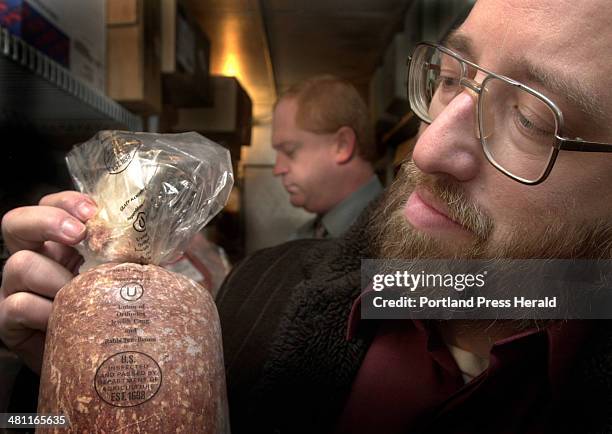 Staff Photo by Fred J. Field, Friday, November 9, 2001: Working in a freezer, Rabbi Isaac Yagod of Portland checks for and finds kosher certification...
