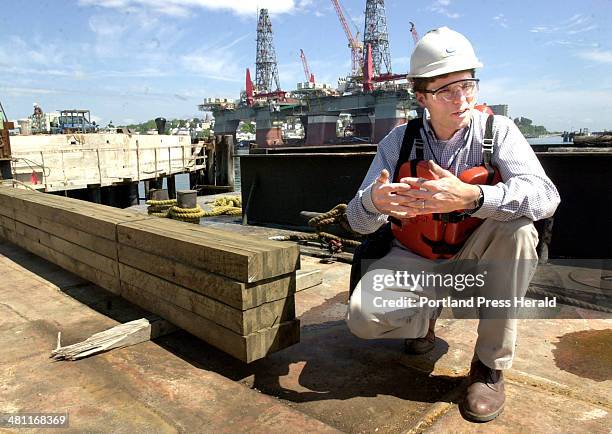 Staff Photo by Doug Jones, Monday, June 23, 2003: Al Putnam, of Engineered Materials of Maine, explains the fingerjoint construction of short pieces...