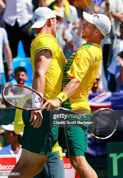 Lleyton Hewitt and Sam Groth of Australia bump chests as they celebrate winning a game as Sam Groth and Lleyton Hewitt of Australia play Andrey...