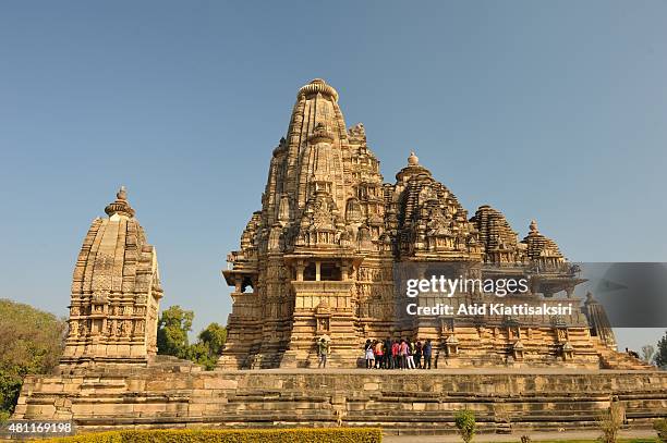 Group of Indian tourists are sightseeing the Vishwanath Temple, one of the Khajuraho group of monuments, a part of UNESCO World Heritage Sites at...
