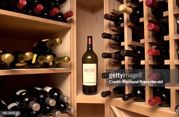 Staff Photo by Doug Jones, Tuesday, February 4, 2003: Wines are accommodated by the case, partial case, and individual bottle in wooden racks in the...