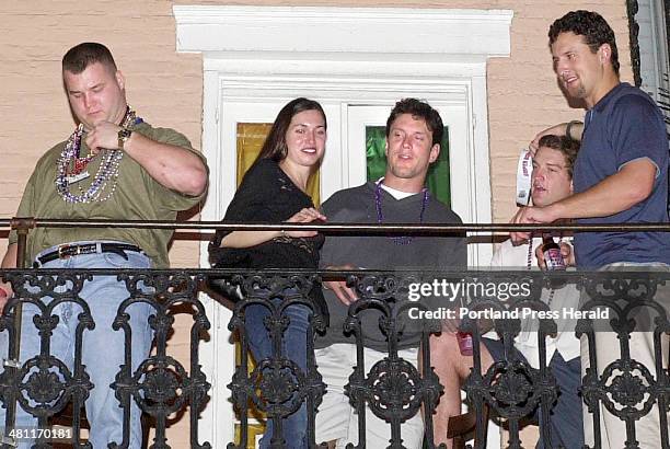 Staff photo by Gregory Rec -- Friday, February 1, 2002 -- Patriots quarterback Drew Bledsoe, third from left, hangs out on a balconly overlooking...