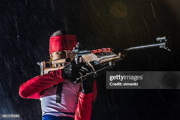 athletic woman with biathlon rifle - trigger stockfoto's en -beelden