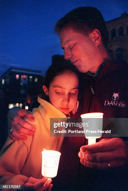 Staff Photo by David MacDonald, Fri, Oct 26, 2001: David Shedd of Portland holds his daughter Allie during a candle-light vigil for Amy St. Laurent...