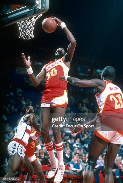 Wayne Rollins of the Atlanta Hawks goes up to grab a rebound against the Washington Bullets during an NBA basketball game circa 1985 at the Capital...