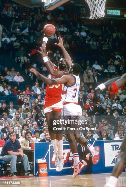 Wayne Rollins of the Atlanta Hawks shoots over John Williams of the Washington Bullets during an NBA basketball game circa 1987 at the Capital Centre...