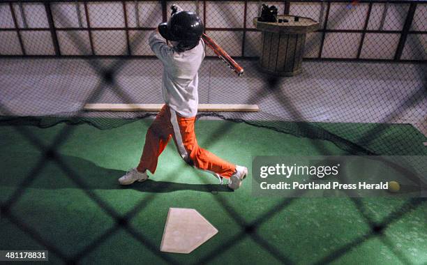 Staff photo by Gregory Rec -- Thursday, April 24, 2003 -- Jen Dutremble gets in some batting practice at Howard Sports in Saco on Thursday. The...