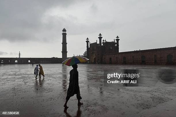 Pakistani devotees leave after offering Eid prayers at the start of the Eid al-Fitr holiday marking the end of Ramadan at the Badshahi Mosque in...