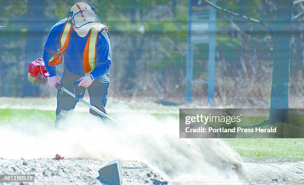 Staff Photo by Gordon Chibroski, Monday, April 14, 2003: Using a mask to keep the silica dust from entering his lungs, Payson Wiers , an employee of...