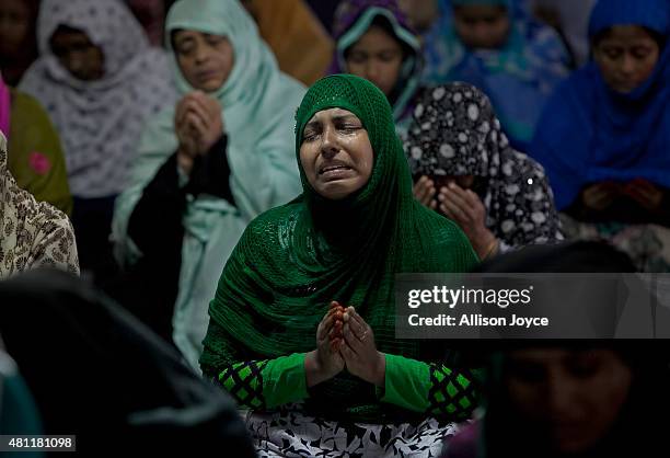 Woman cries as she prays at Baitul Mukarram, the National Mosque, on Eid Al-Fitr July 18, 2015 in Dhaka, Bangladesh. Muslims around the world are...