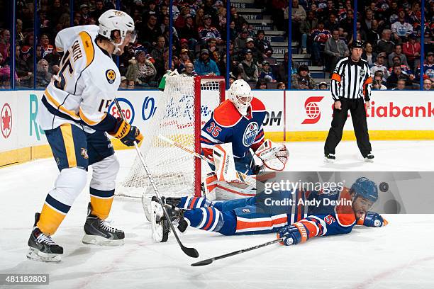 Mark Fraser of the Edmonton Oilers blocks a shot from Craig Smith of the Nashville Predators on March 18, 2014 at Rexall Place in Edmonton, Alberta,...
