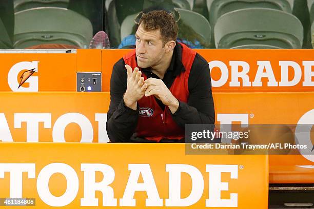 Dejected Travis Cloke of the Magpies sits on the bench at 3/4 time with an injury during the round 16 AFL match between the Collingwood Magpies and...