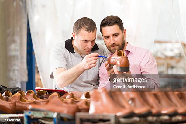 young businessman and manual worker - shoe factory stock pictures, royalty-free photos & images