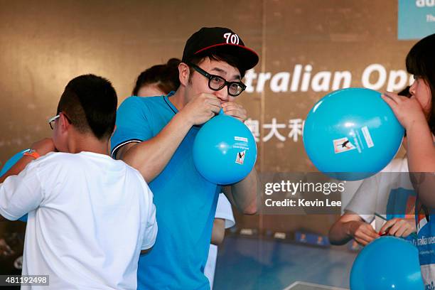 Chinese pop senstion Wang Zhengliang competes with children in balloon blowing competition at an Australian Open 2016 event on July 19, 2015 in...