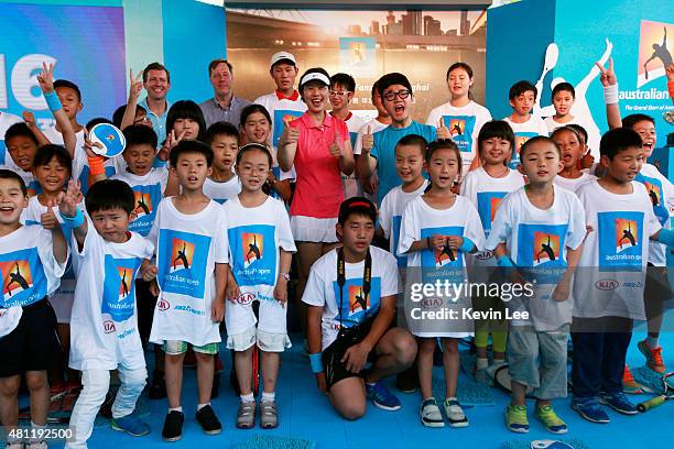 Olympic gold medallist Sun Tiantian poses with children at an Australian Open 2016 event July 19, 2015 in Shanghai, China.