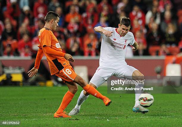 James Milner of Liverpool competes with Steven Lustica of Brisbane Roar during the international friendly match between Brisbane Roar and Liverpool...