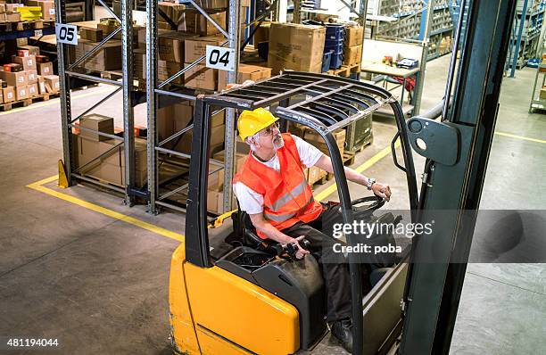 forklift operator at warehouse loading, lifting - shovel stockfoto's en -beelden