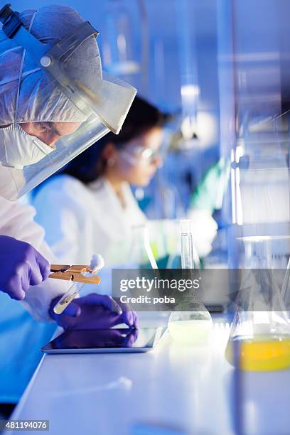 group of scientists working at the laboratory - science stock pictures, royalty-free photos & images