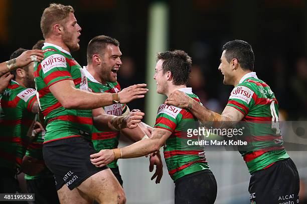 Tom Burgess, Tim Grant, Adam Reynolds and Bryson Goodwin of the Rabbitohs celebarte after 7 scored a try during the round 19 NRL match between the St...