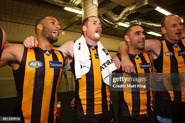 Josh Gibson, Jarryd Roughead and Shaun Burgoyne of the Hawks sing the club song after during the round 16 AFL match between the Sydney Swans and the...