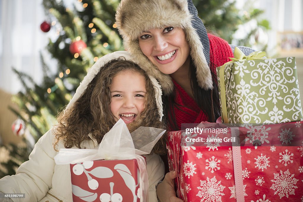 Mother and daughter holding presents