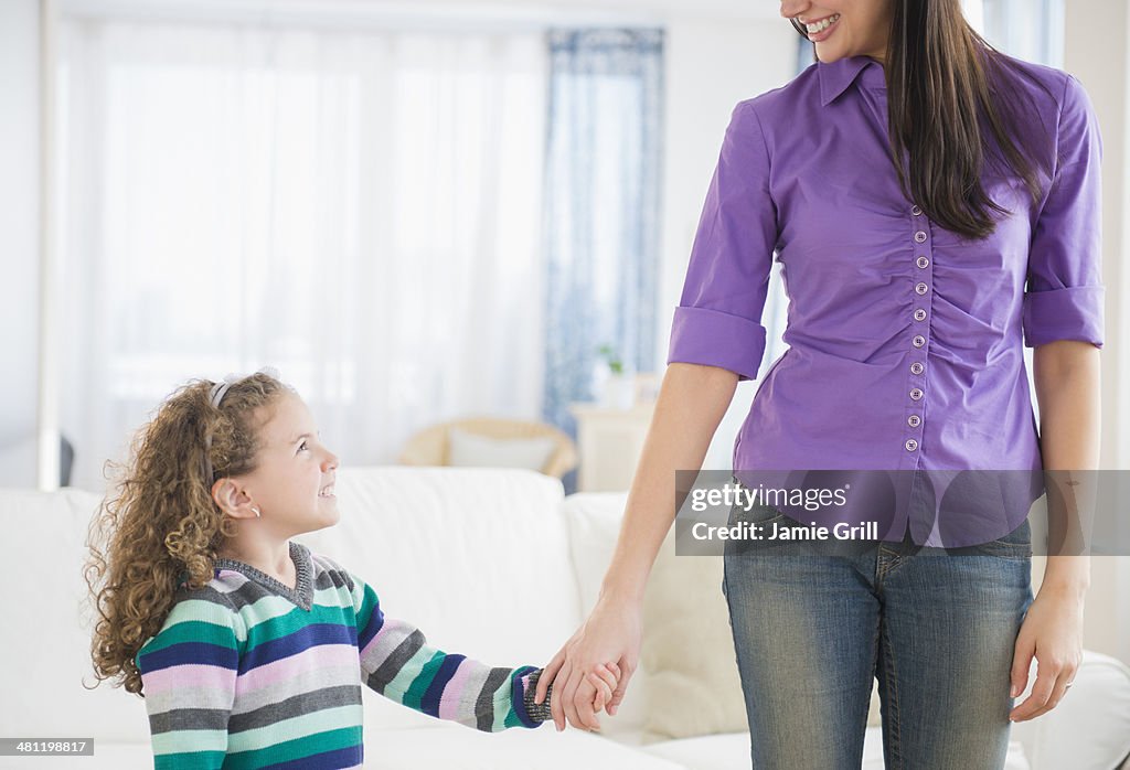 Mother and daughter holding hands