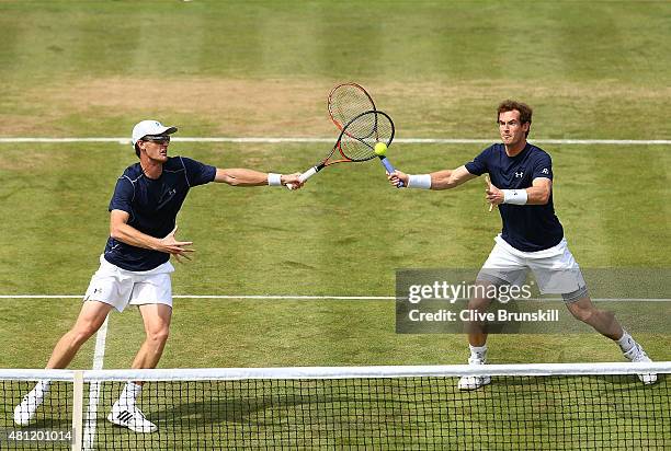 Jamie Murray and Andy Murray of Great Britain in action in their match against Nicolas Mahut and Jo-Wilfried Tsonga of France during Day Two of the...