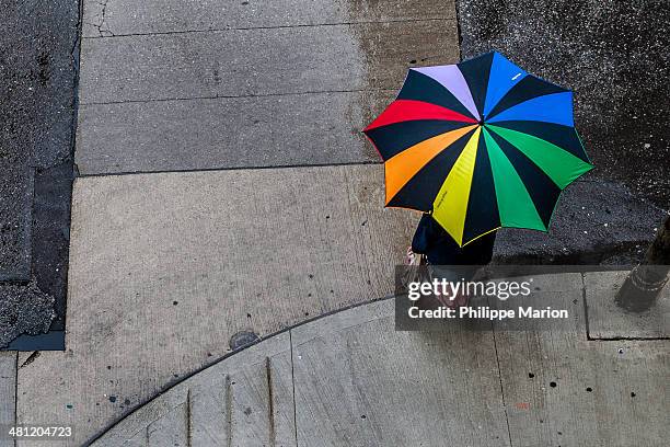 rainbow colored umbrella on a rainy day - marion street stock pictures, royalty-free photos & images