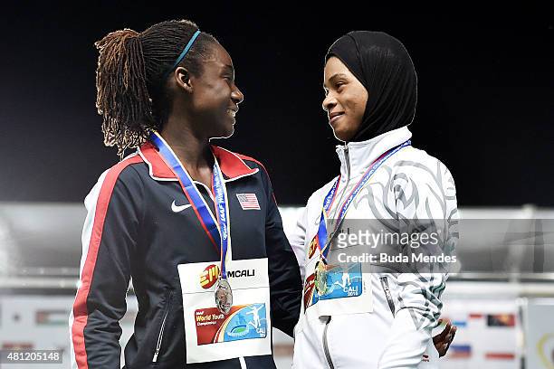 Salwa Eid Naser of Bahrain, gold medal, and Lynna Irby of the USA, silver medal, celebrate on the podium after the Girls 400 Meters Final on day...