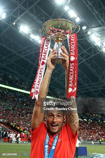 Olivier Giroud of Arsenal celebrates with the trophy after they defeated Everton 3-1 during the Barclays Asia Trophy final match between Arsenal and...
