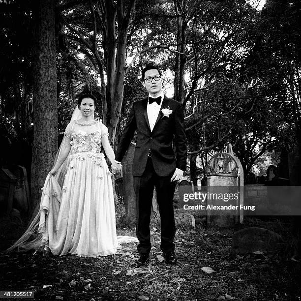 Bride & Groom holding hands in a graveyard