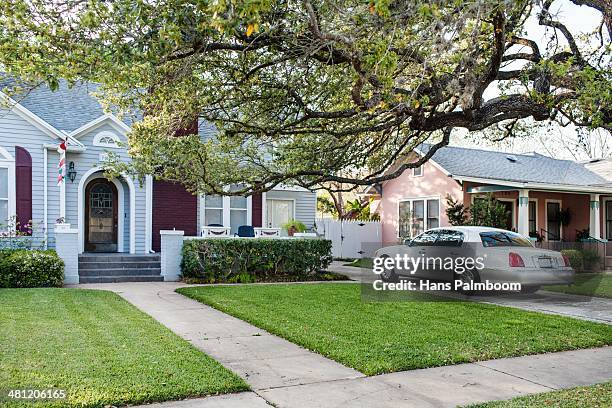 Typical American suburban house with a luxurious car in the driveway