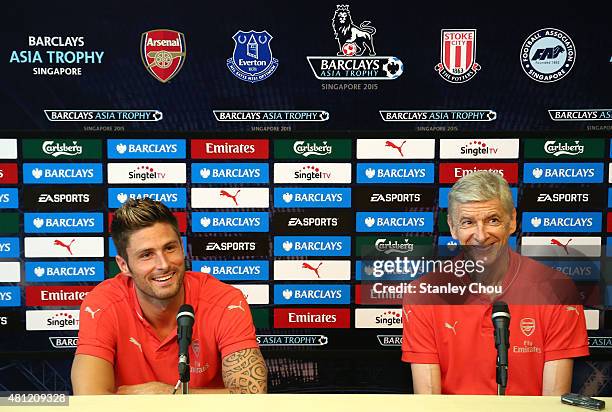 Arsene Wenger manager of Arsenal and Olivier Giroud speaks to the media during the post match press conference after they defeated Everton 3-1 during...