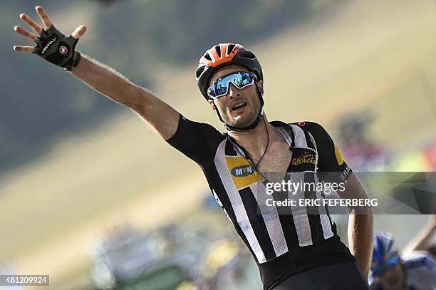 Great Britain's Stephen Cummings flashes the number five as he celebrates after crossing the finish line at the end of the 178,5 km fourteenth stage...