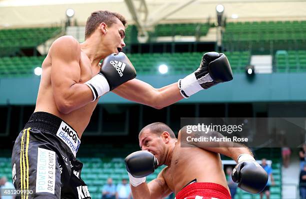 Misa Nikolic of Serbia exchange punches with Leon Bauer of Germany during the super middleweight fight at Gerry Weber Stadium on July 18, 2015 in...