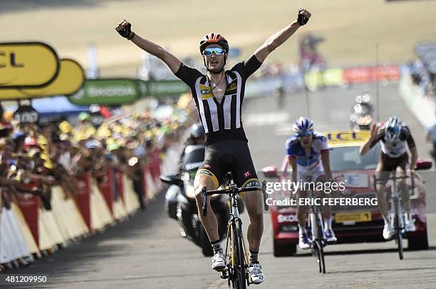 Great Britain's Stephen Cummings celebrates as he crosses the finish line ahead of France's Thibaut Pinot and France's Romain Bardet at the end of...