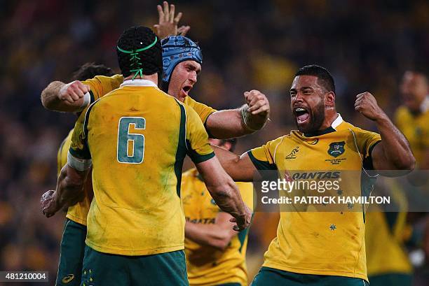 James Horwill embraces Scott Fardy and Tatafu Polota-Nau of Australia as they celebrate their victory after the Rugby Championship Test match between...