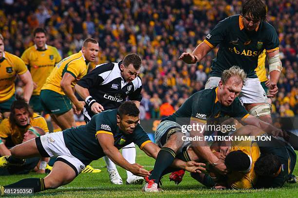 South Africa players Bryan Habana and Schalk Burger rush to tackle Tevita Kuridrani of Australia to stop a try on full time, during the Rugby...