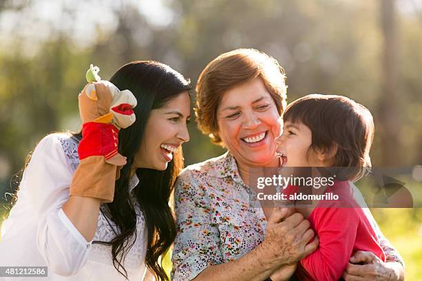 happy family playing with a puppet - mexican picnic stock pictures, royalty-free photos & images