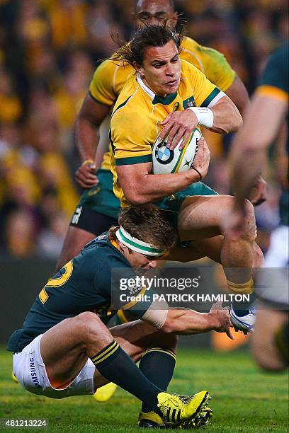 Matt Toomua of Australia is tackled by Damian de Allende of South Africa during the Rugby Championship Test match between Australia and South Africa...