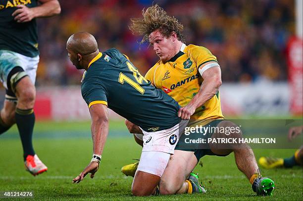 Pietersen of South Africa is tackled by Michael Hooper of Australia during the Rugby Championship Test match between Australia and South Africa at...