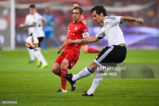 Philipp Lahm of FC Bayern Munchen tries to control the ball with Lucas Orban of Valencia Club during the match between FC Bayern Munchen and Valencia...