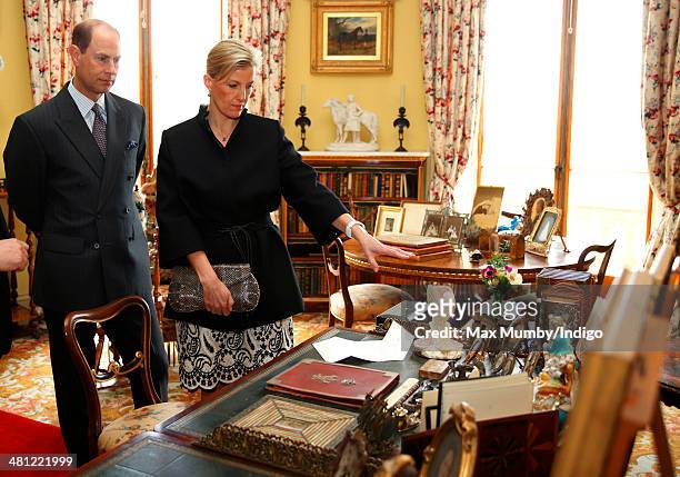 Sophie, Countess of Wessex and Prince Edward, Earl of Wessex view Queen Victoria's and Prince Albert's writing desk as they tour Osborne House during...